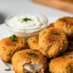 Golden brown crispy air fryer chicken bites served on a plate. Delicious and easy to make!