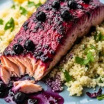 Close-up of blueberry glazed salmon fillet served over lemon herb couscous. Ready to eat!