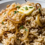 Close-up of creamy caramelized onion butter rice, ready to eat. Perfect side or main dish.