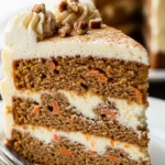 Close-up of a slice of Carrot Cake Cheesecake, showing the layers of carrot cake and creamy cheesecake. Perfect for dessert!