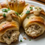 Creamy Chicken Crescent Pillows: Flaky crescent rolls filled with creamy chicken and topped with Parmesan sauce.