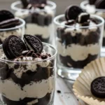 Close-up of easy cookies and cream dessert cups, layered with Oreo cookies and whipped cream.