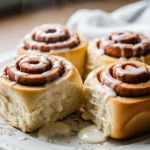 Close-up of warm, gooey gluten free cinnamon rolls with cream cheese frosting. The best gluten free cinnamon rolls recipe!