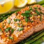 Close-up of perfectly baked maple Dijon salmon, glistening with glaze.