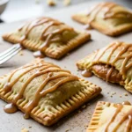 Close-up of homemade pumpkin pop tarts with maple glaze, perfect for fall baking.