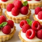 Close-up of creamy vanilla raspberry tarts, a delicious and easy dessert recipe.