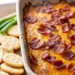 Creamy smoked Gouda dip in a bowl, garnished with herbs and served with crackers. Perfect party appetizer.
