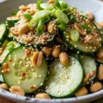Close-up of spicy peanut cucumber salad in a bowl, showcasing the vibrant colors and creamy dressing.
