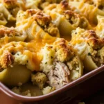 Golden brown Turkey Stuffed Shells with gravy and melted cheese, ready to serve. A perfect Thanksgiving leftover recipe!