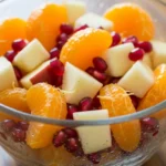 Delicious Winter Fruit Salad with Cinnamon Vanilla Dressing in a glass bowl. The perfect holiday appetizer.